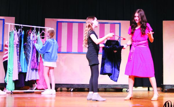 “Omigod You Guys”…Shopping for the perfect dress, eighth grader Kate Repsher (left) and eighth grader Millie Moffatt (right) show off their fashion knowledge to sixth grader Julie Landgrebe in the opening song of Indian Crest Middle School’s “Legally Blonde, Jr.” 
