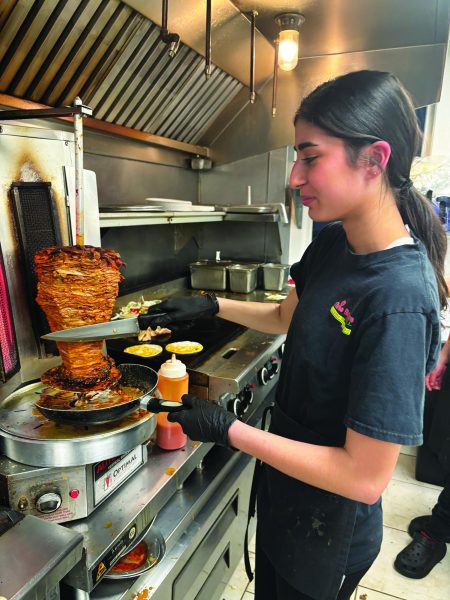 Slice by slice… Assembling for Taco Tuesday at Three Brother Mexican Grill in Harleysville, server Sonia Dharmani helps out with kitchen prep. Employees cut and served fresh pastor tacos to customers bringing the taste of Mexican culture to the community.  
