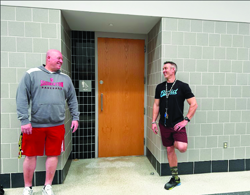 Vape police… Standing on guard, wellness teachers Josh Wagner (right) and Mike Childs stand outside the men’s bathroom to patrol for students vaping. Patrolling bathrooms was found to be the most effective way to stop the vape problem. 