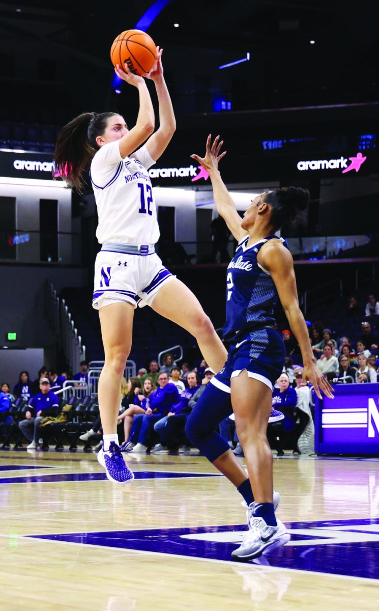 Performing+under+pressure%E2%80%A6Shooting+a+mid-range+2-pointer%2C+Northwestern+Wildcats+point+guard+Casey+Harter+plays+against+the+Penn+State+Nittany+Lions.+The+final+score+was+76-65+in+favor+of+the+Nittany+Lions.