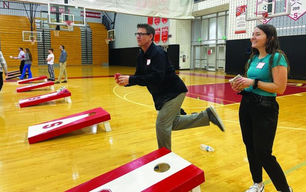 Corning around…Enjoying the competition, guidance counselor Daniel Glatts and math teacher Kelly Nevenglosky participated in the Cornhole Club’s tournament on February 29.  