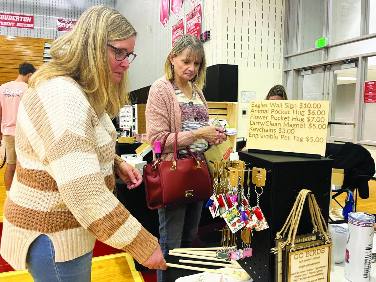 Shopping for handmade goods, Souderton residents Donna Gasner (left) and Linda Tulino check out a keychain display at the Link Crew’s Craft Fair and Mommy Market. The event took place in Souderton’s gym on March 9. 