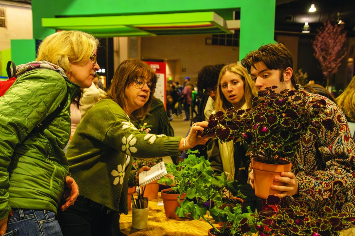 Rooting for a ribbon…Reviewing his challenge plant one last time before submission, senior Cayden Johnson (right) inspects each leaf with environmental science teacher Kim Wilson (left) and Philadelphia Flower Show student liaison Pam Snyder. Students attended the event on March 4.