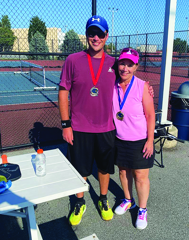 Pickleball...Posing for a picture at a pickleball tournament, pickleball player Joanna Jiruska shows off her medal.