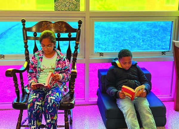 Cozying up for competition…While reading in the Rainbow Cafe at Oak Ridge Elementary School, 4th graders Sahasra Gorrepati (left) and Isiah Brown prepare for this year’s Reading Olympics on March 21. Students have been preparing  for the competition since December. 
