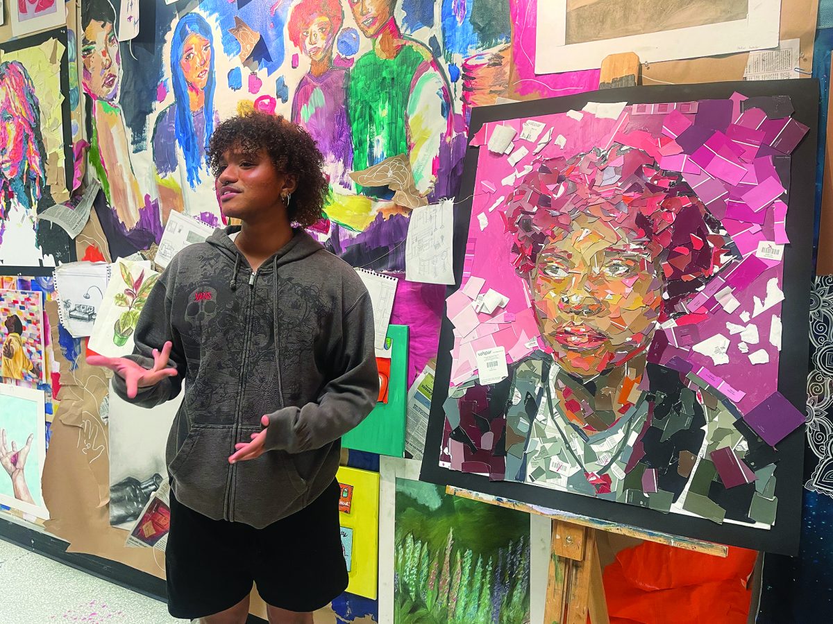 Seeing+double...Sharing+his+self+portrait+at+the+art+show%2C+senior+Andrew+Mathuthu+discusses+his+piece+with+community+members.+The+art+show+took+place+May+3-4.