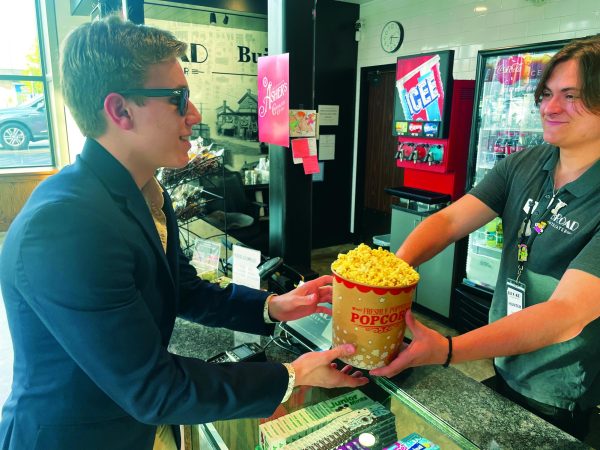 Falling for it…Buying popcorn from Broad Street Theater employee Hunter Haight, sophomore Elijah Bleazard prepares to watch “The Fall Guy” for the first time. “The Fall Guy” was released to theaters on May 3 and stars actor Ryan Gosling.
