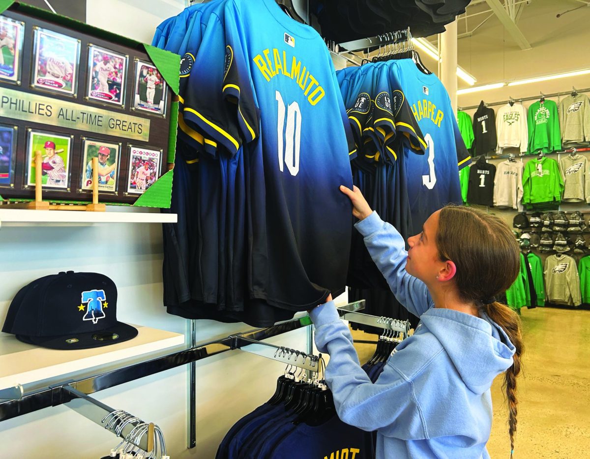 Only the best…Shopping for a new Phillies jersey, sixth grader Camryn Hoover reaches for a City Connect jersey from Rally House’s selection. Team members first sported the uniform at an April 12 home game. 