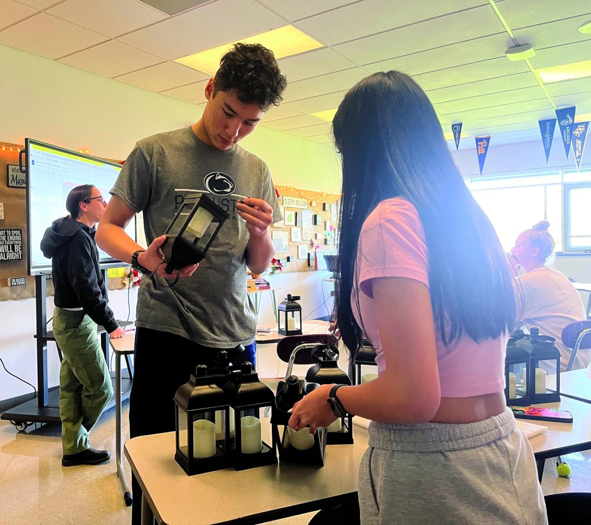 Getting ready…To prepare for the April 27 junior prom, Student Government members Colton Musselman (left) and Kayla Lelina sort decorations. The Class of 2025 must begin the decorating process by assemeling lanterns. 
