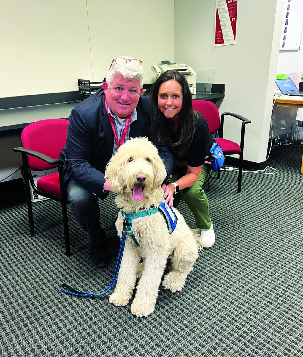 A ‘pawsome’ addition…After welcoming therapy dog Wheeler into the high school, Superintendent Frank Gallagher and guidance counselor Nicole Trout enjoy Wheeler’s company. 
