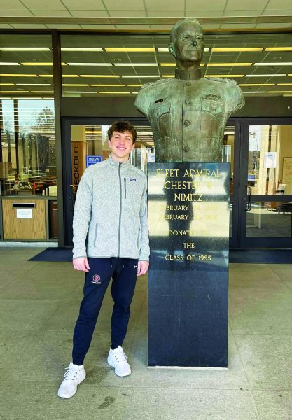 Newest recruit...Visiting the United States Naval Academy on March 1, senior Aidan Kearns poses with a statue of U.S. Fleet Admiral Chester Nimitz, who graduated from the Naval Academy in 1955. Kearns will attend the Naval Academy this fall.