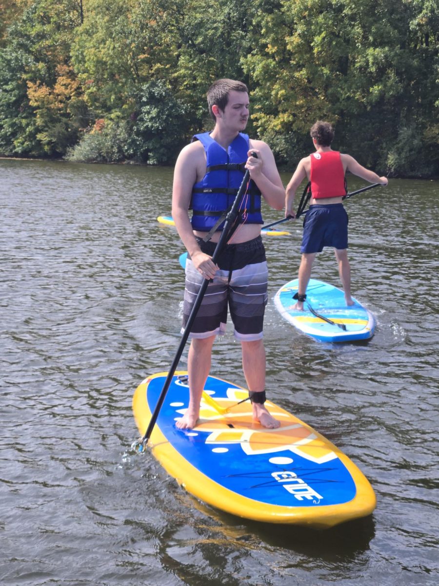 Paddling...Experiencing paddleboarding, junior Jacob Keenan attempts newfound skills during a recent Outdoor Adventure and Fitness trip. 