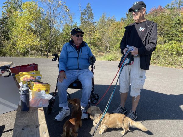 Soaking in the “paw-some” weather...Enjoying time together at Peace Valley Park in Doylestown on October 6, Korean War veteran Joel Occhiuzzo chats with Chalfont resident Ron Alfors and his two miniature dachshunds, Ernest (left) and Howard.