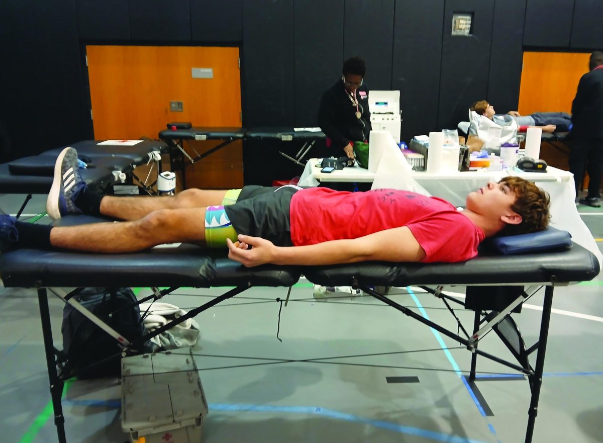 Behind the scenes … Supporting the Red Cross, donor Ruth Lemos lays and gives blood to help those in need. The blood drive took place throughout the school day on October 29.