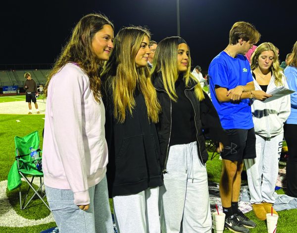 Spiritually connecting…Worshipping with peers, (from left) seniors Julia DeCaro, Reece Pirrone and Isabella Padilla attend Fields of Faith on October 30 at the high school’s Grandview Health football stadium. Fellowship of Christian Athletes hosted the event where community members connected on a religious level through music and testimonies.