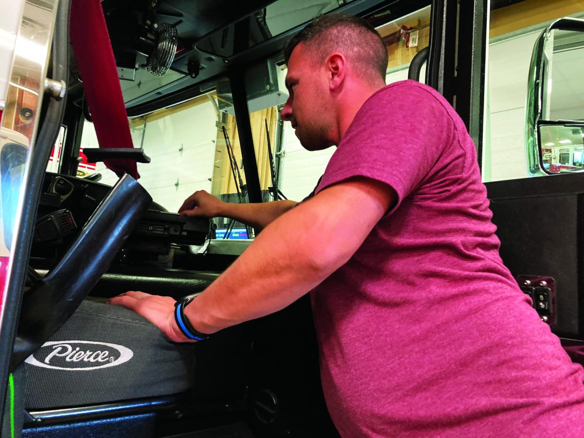 Teaching youth...Presenting one of the Souderton Volunteer Fire Department’s fire engines, volunteer firefighter Steve Costa explains the computing system inside. The system is used to help gather information and operate the vehicle.