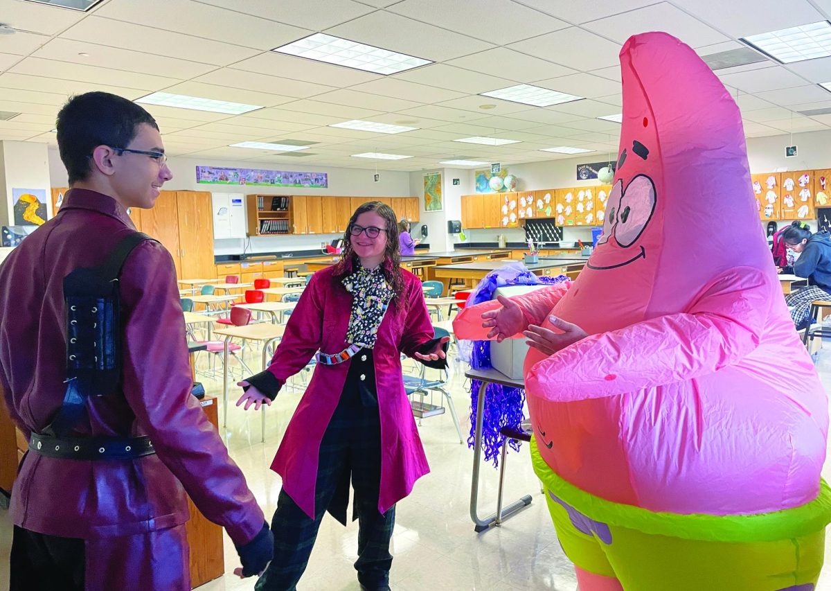 Too ghoul for School… Having a chat in Mrs. McDonough’s room, sophomore Bryce Russell (left), junior Regan Dunlevy (center) and junior Yahir Perez (right) talk about their costumes and Halloween plans. They were enjoying their Halloween morning, spending Redzone together. 