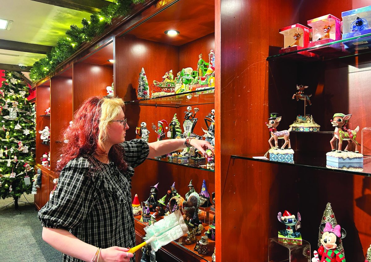 Preparing for the holidays…Completing her closing tasks, Pine Wreath & Candle employee Alexa Giorgio dusts the shelves to keep the displays neat for each visitor. Pine Wreath & Candle is one of the numerous shops that reside at Peddler’s Village in Lahaska, Pa.