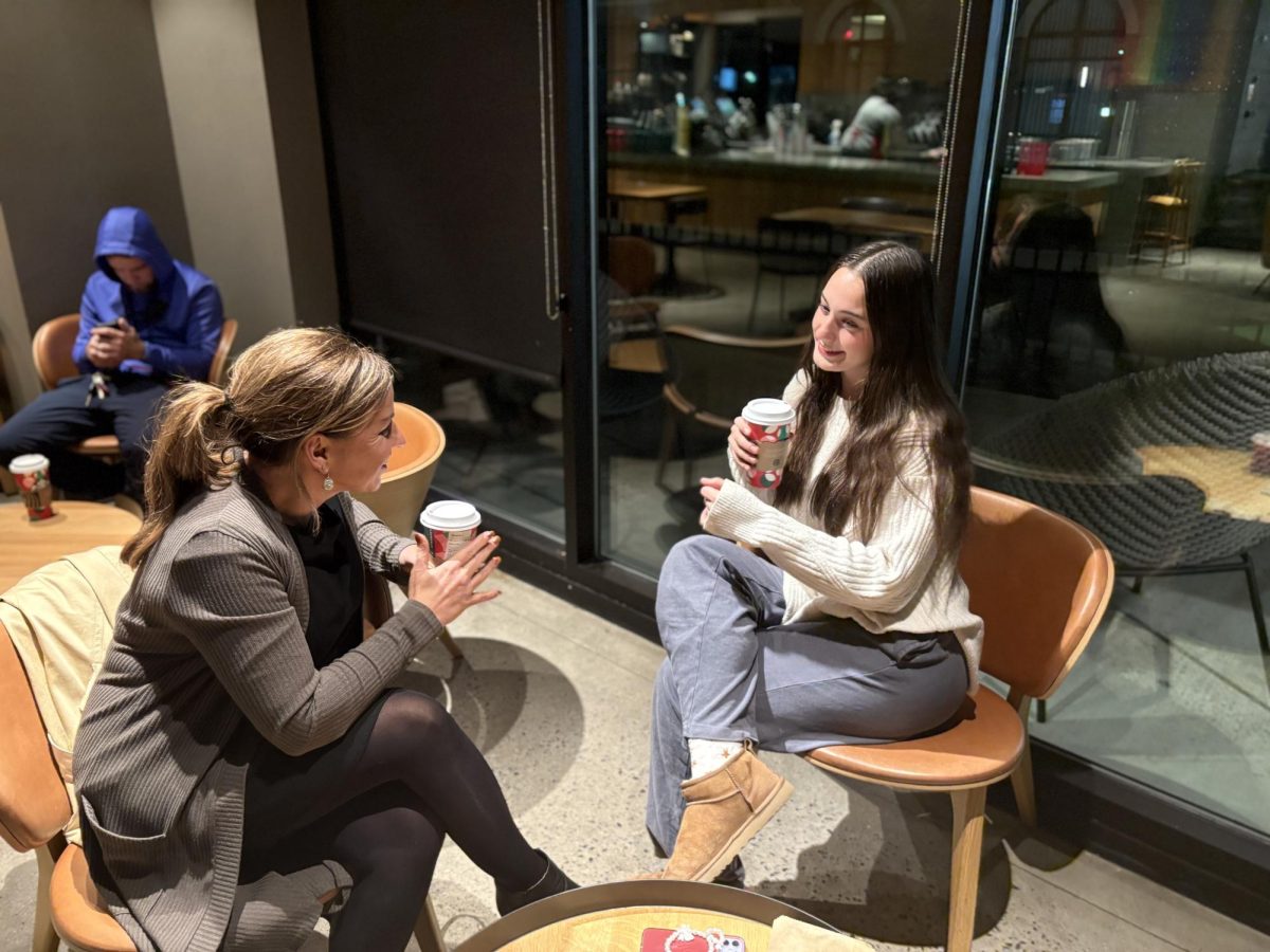 A ‘tea’rific night...Bonding and sipping on festive drinks, customers Heather Helfrich (left) and Natalie Helfrich spend quality time in Starbucks. The corporation released their holiday drink menu on November 7.