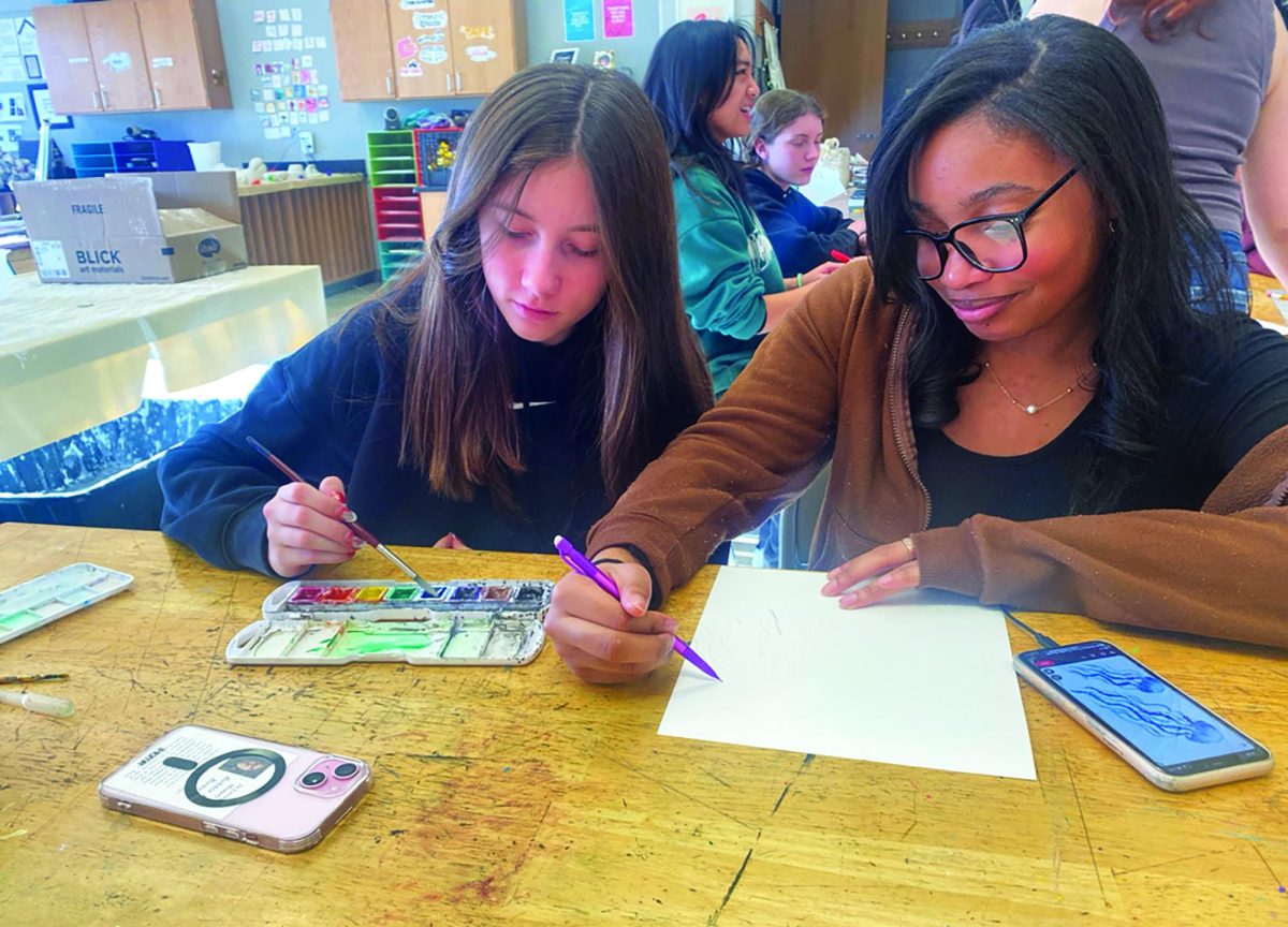 Spending time together by painting with watercolor in room B116, sophomores Jaelynn Lutcher (left) and Skyy Richardson attend an Art 4 Social Change meeting to paint.