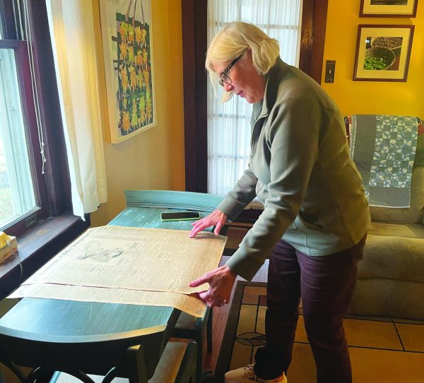 Solving the puzzle…Looking at pages from the old Souderton Independent newspaper, Souderton Independent primary researcher Cory Alderfer watches a town “grow.” Alderfer looks at six months to one year’s worth of the newspaper at a time. 