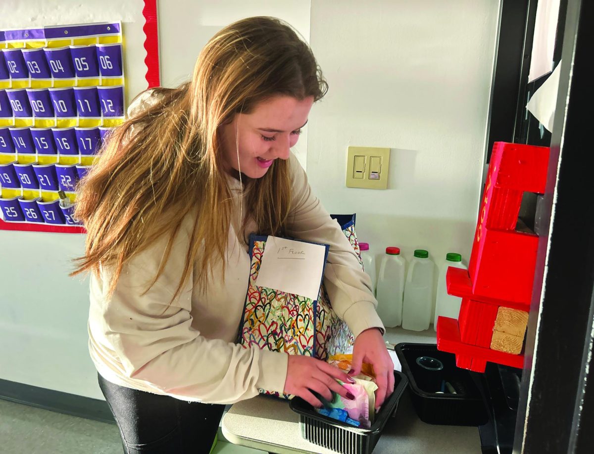 Renewing access...Restocking baskets of period products throughout the first floor, Recycle the Cycle Club member Emily Clemens helps make sure that every female in the high school has access to free and accessible menstrual products.