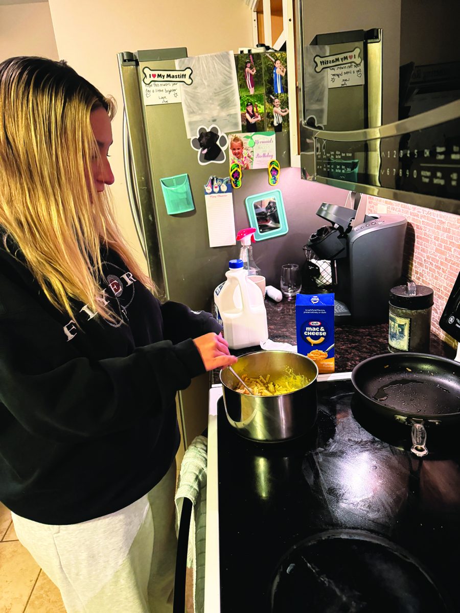 Krafting…Enjoying some quality time in the kitchen, senior Avari Schlegel prepares her first bowl of mac and cheese to review.     