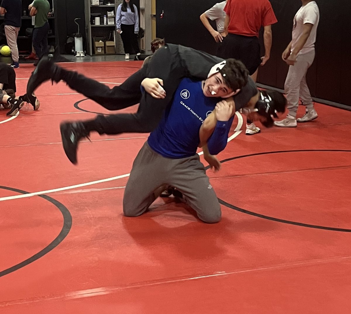 Ready to rumble... Practicing for upcoming matches, senior Jake Thanel works on his over-the-shoulder drag with senior Dom Ramos as his opponent. The practice took place on December 19, 2024.