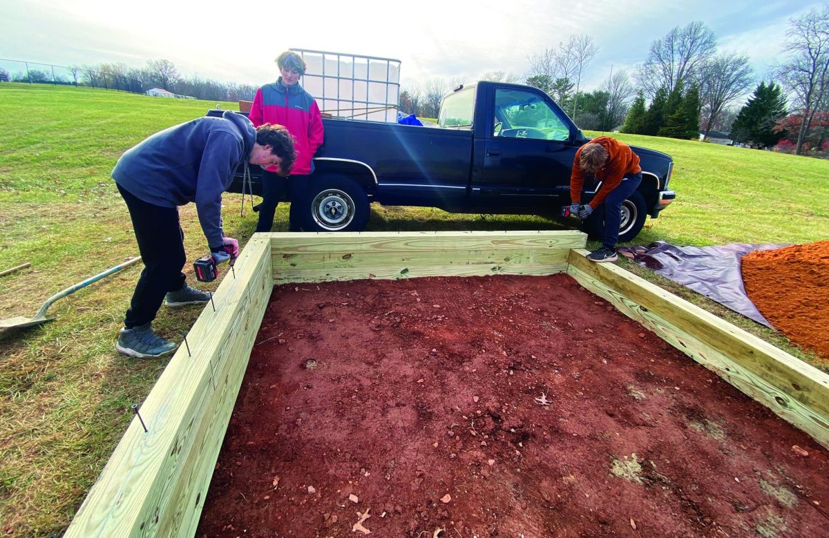 Score…To help finish Eagle Scout candidate Charlie Hunsicker’s project, (from left) juniors Braydon Godfrey, Nate Bucher and Nate Martin help start the project. The project was to make a scoreboard and dugout for Indian Crest Middle School’s baseball field.