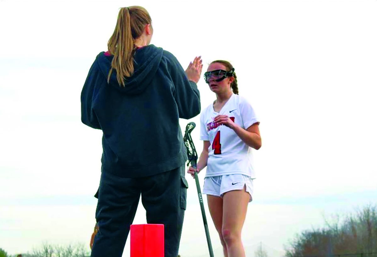 Helpful advice…Giving game feedback, head coach Karli Gilbert (left) speaks to player Cailee Cush (right)  during her substitution. With the coaches help, players can help get an insight of what their coaches are noticing on the field so they can improve their playing skills
