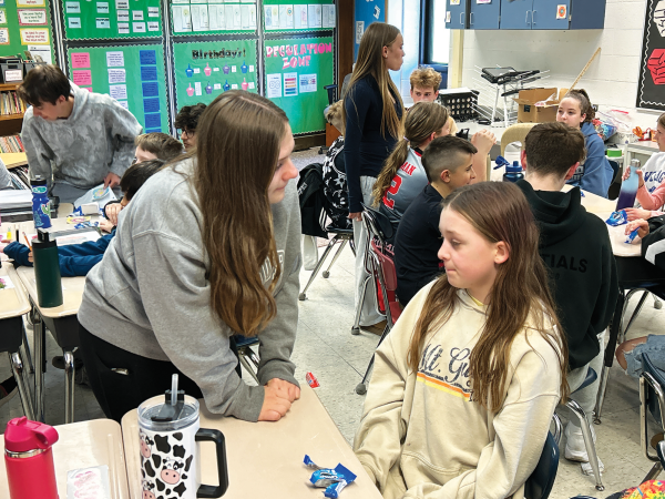 Conversation ensues...Connecting students together, Key Club member Kendall Moyer (left) visits fifth-grade pen pal Aria Coyler. 
