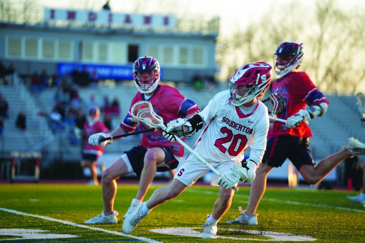 Cradling...Dodging out of the way of his defenders, senior Chris Lewis looks to take the ball up the field. After a double overtime thriller on April 9, Souderton beat the CB East Patriots 8-7.
