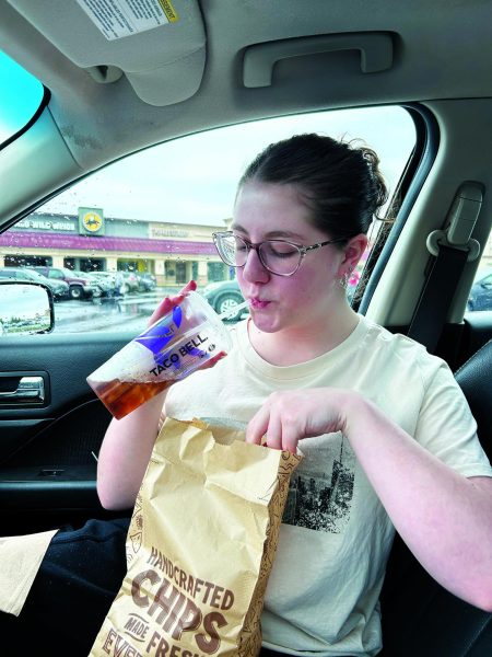 ‘Live Mas’...Enjoying her Taco Bell drink and Chipotle chips, junior Julia Sipes compares the two popular Mexican cuisines. For Sipes, Taco Bell won the debate. 