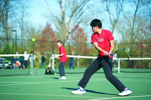 Double the fun...Competing in a doubles tennis match, sophomore Nate Chou (foreground) and freshman Chase Foley focus on winning a point. Souderton won the day against Pennridge High School on April 9 with a final score of 5-2.