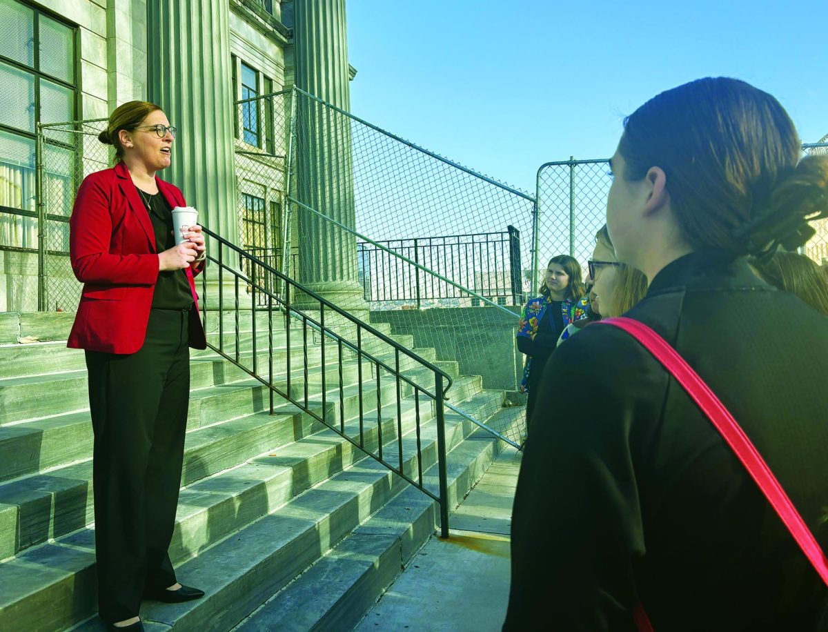 Looking into law...Discussing the day’s agenda on the Montgomery County Courthouse, Deputy Court Administrator Alexandra Hasapes (left) informs members of the Women’s Studies class of the plans for their March 19 visit.