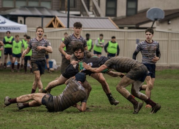 Securing the tackle…Crowding to tackle the ball carrier, Lock Jeff Dan Ulmer (bottom left), 8 man Ian Gallagher (center) and outside center Eli Ekhardt (Right) tackle a Blackthorn player. Montgomery Rugby Club took down Blackthorn Rugby Club 25-5 on April 6.
