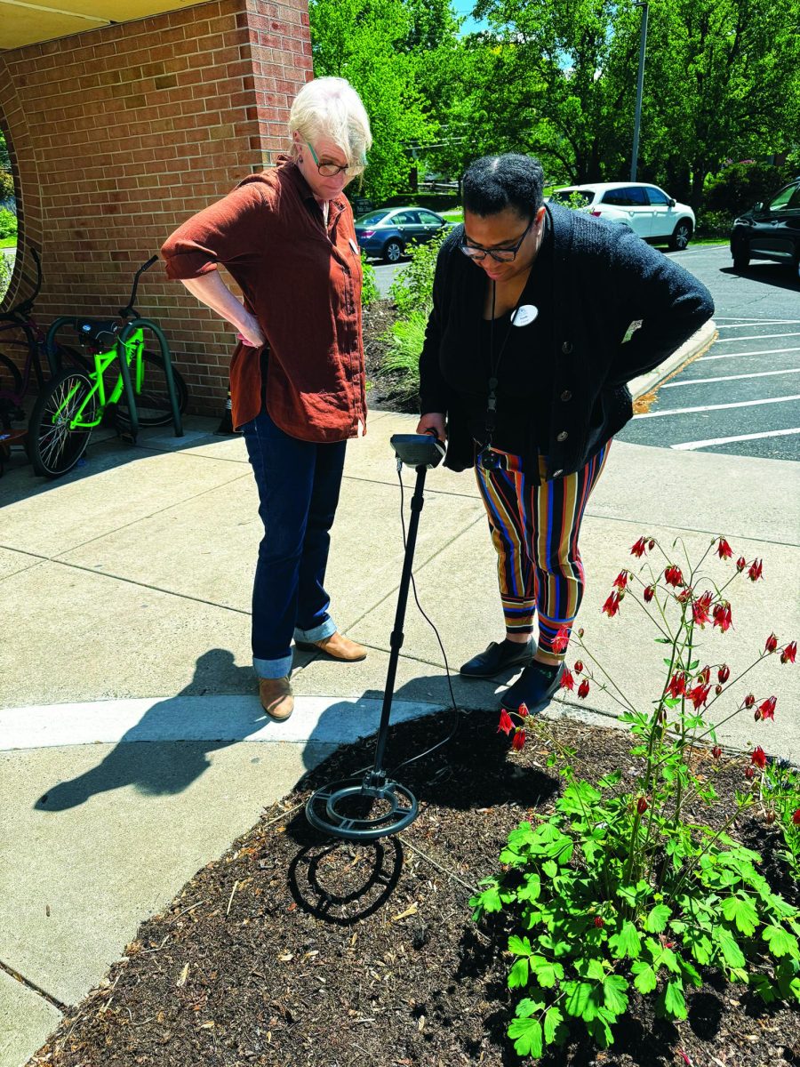 Pinging…Testing out the metal detector from the IVPL’s Library of Things, outreach services librarian Nicole Husbands (right) searches for lost items while library director Tracey Reed assists. The Library of Things is open for anyone with a library card.