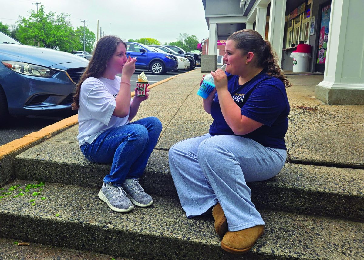 The inside scoop…Enjoying their Rita’s treats on a cloudy day, juniors Julia Sipes (left) and Aubrey Gehman anticipate summer vacation.
