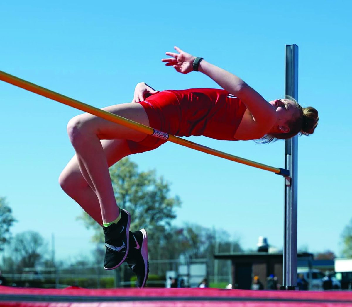 Leaping new heights…Displaying her vertical in the high jump, senior Elizabeth James competes at a track meet this season. High jumpers work hard to increase their leg strength.