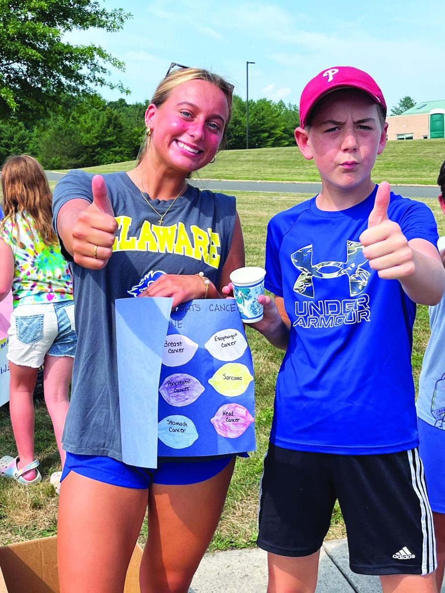 ‘Squeeze’ the day…Raising money for Alex’s Lemonade Stand, Oak Ridge Camps science coordinator Adrianah Petrovich and camper Connor Kneeland sell lemonade in July 2024.