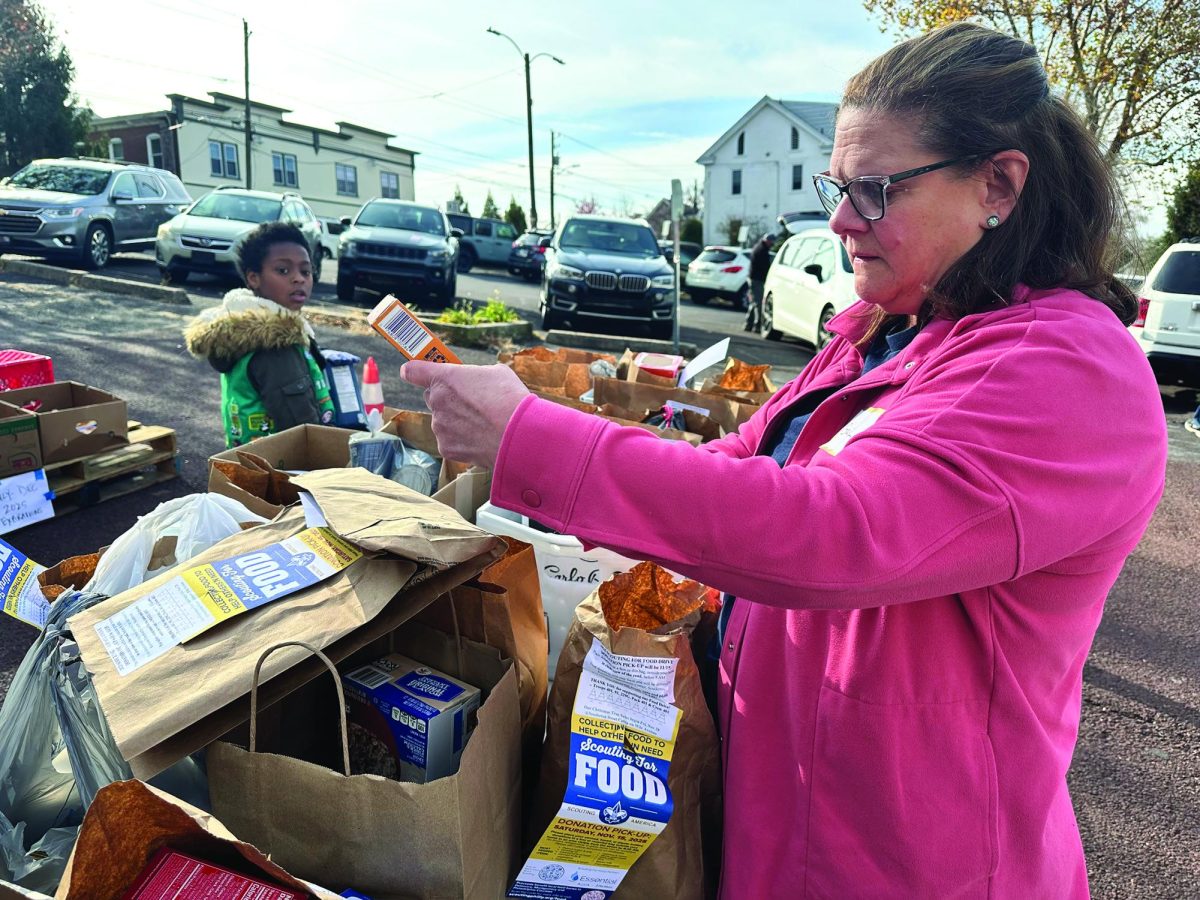 Making a difference...Helping the community, Keystone Opportunity Center volunteer Gail Ramsey packages food donations on November 15. Volunteers were able to raise over 17,000 pounds of food for families during the holiday season.