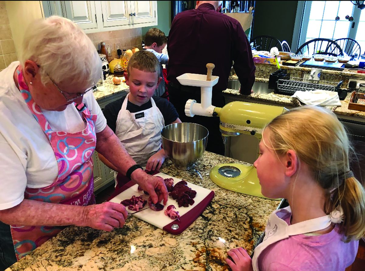 Slicing and dicing...Preparing homemade stuffing for their 2018 Thanksgiving, grandmom Sue Hope (left), grandson Mitch Ziegler (center) and granddaughter Kami Ziegler grind up turkey parts. This is a tradition and staple for the annual Hope family Thanksgiving.

