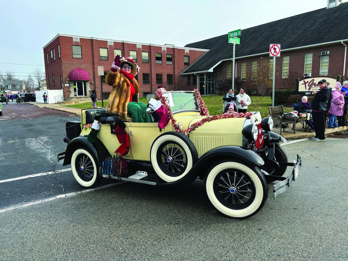 Rolling out in style...Kicking off the Souderton Holiday Parade, North Penn Ford Model A Club member Beth Howard waves to the crowd. The parade took place on December 6, from 11-1 p.m.
