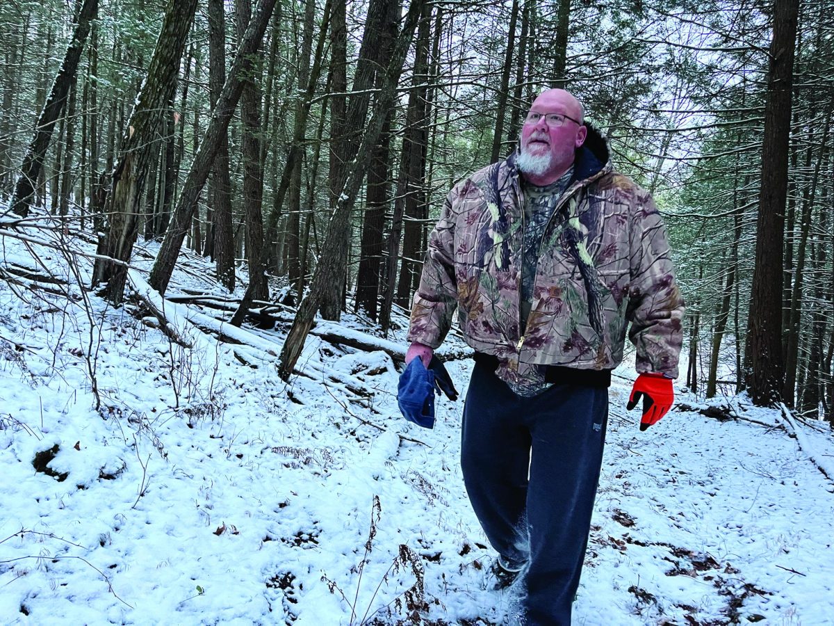 Blazing a new trail...Hiking through the woods, hunter Mike Daley looks for deer. This year’s deer season took place November 29 through December 13.