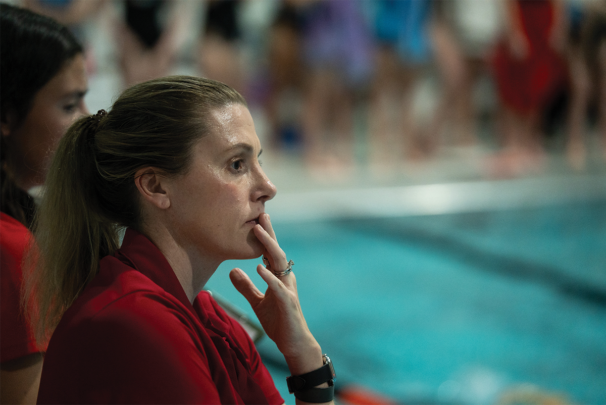 Constant vigilance…Monitoring the team during their second practice of the season on November 17, head coach Heather Moore analyzes the swimmers as they warm up. This was the first practice that Moore attended.
