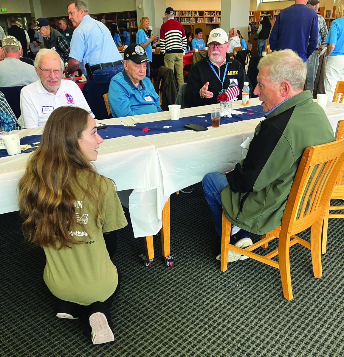 Showing gratitude…Helping celebrate veterans, Support Our Troops Club member Kayla Smith converses with Peter Becker resident Stephen Nelson about his experiences in the Vietnam War. The annual Veterans brunch took place on November 1, from 11 a.m. to 1 p.m. in the Library.