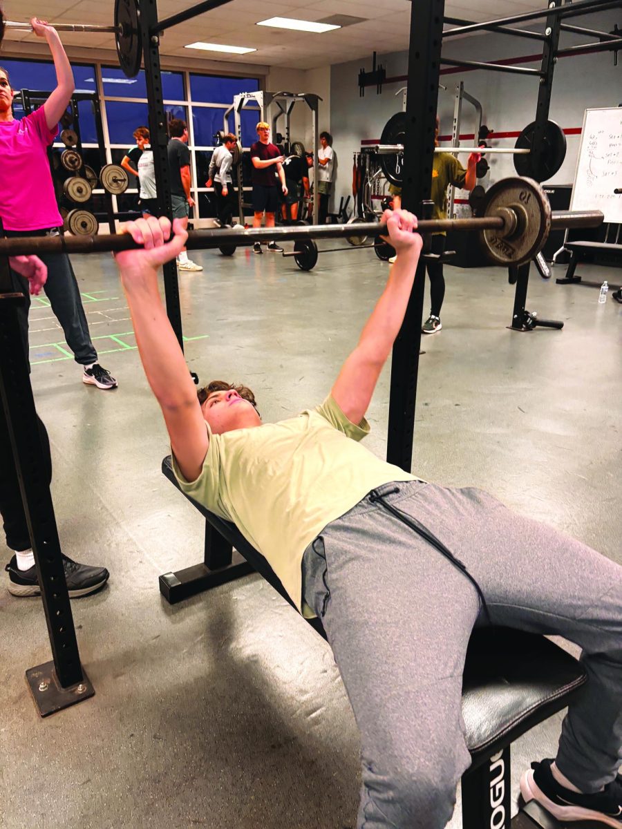 Getting in reps…Hitting the weight room on November 19, sophomore Liam Kratz (center) and the rest of the boys indoor track team look to strengthen for the upcoming spring season. The indoor season will run from October to March, and the team will compete in 17 meets.