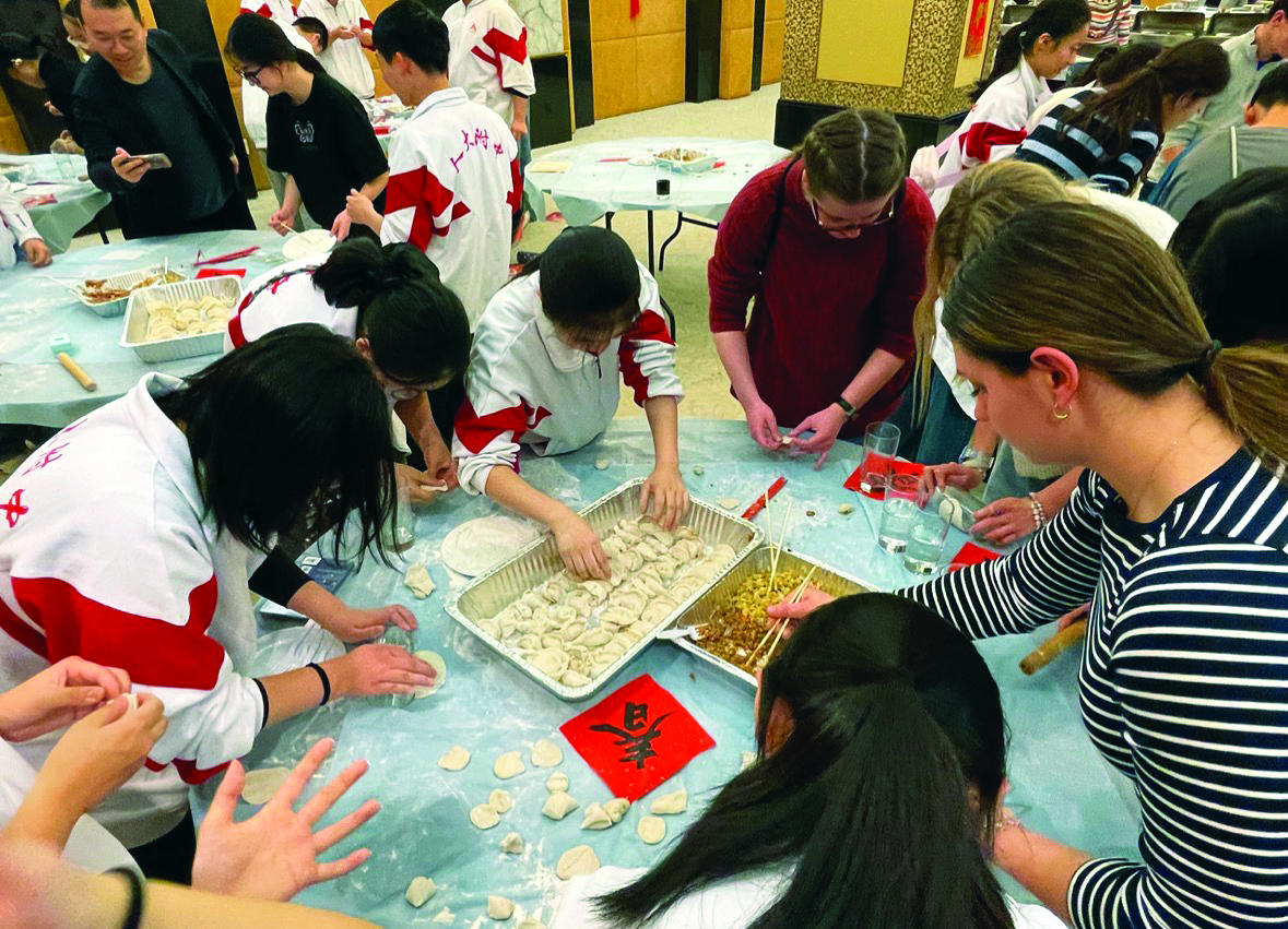 Learning new recipes...Making dumplings (from right), senior Ava Detwiler, sophomore Mia Lapp and junior Kate Meyer connect with visiting Chinese students. The Chinese Consulate Youth Lunar New Year celebration took place at the Chinese Consulate in New York City on February 19. Approximately 100 Souderton students were invited to attend the event designed to allow students from both countries an opportunity to share cultural experiences.