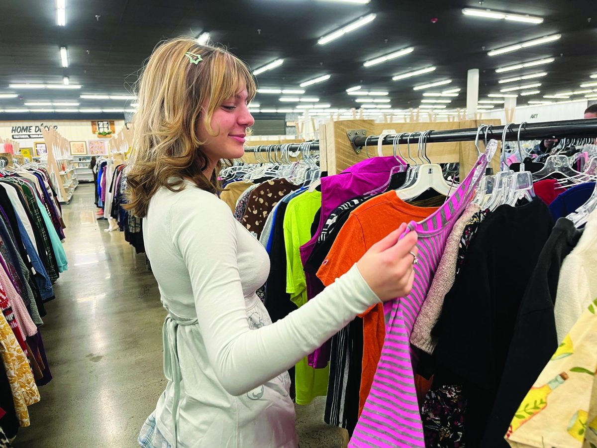 “Goodwill Hunting”...Searching for the perfect shirt, junior Mallory Stutzman sifts through Liberty Thrift Store’s selections on February 27. The store is located on Route 113 in Souderton.
