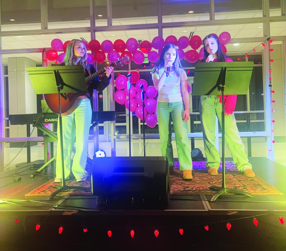 Singing out… Performing at Souderton’s very first Valentine's Day cabaret, sophomores Devon Naylor (middle) and Anna Cook (right) sing a song to help fundraise for the choir while sophomore Jane Bennett (left) plays guitar.
